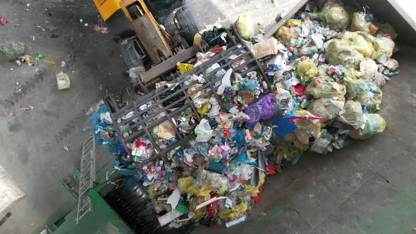 Aerial View of Trash Sorting Facility Garbage Crusher Being Loaded by a Bulldozer alt