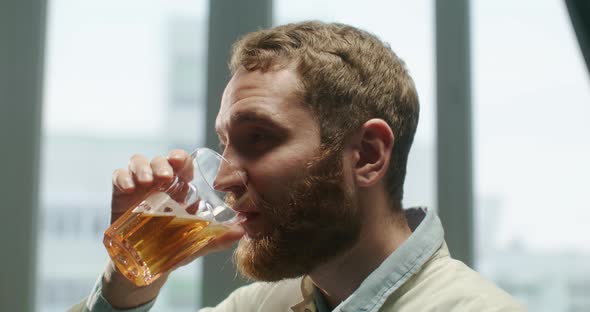 Calm and Charming Man Enjoying a Beer