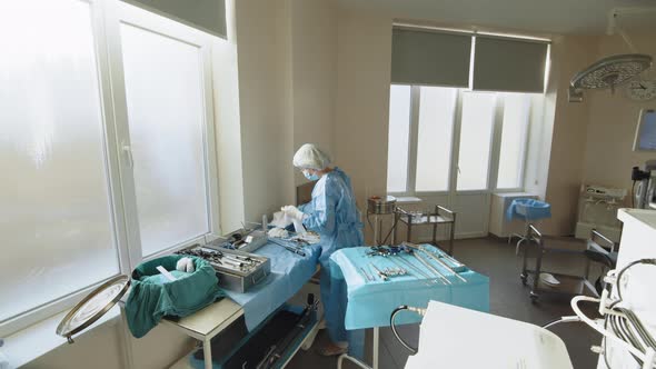 Portrait of a Female Healthcare Worker in a Protective Mask Standing at a Table alt