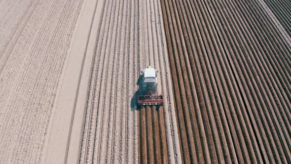 Tracking Shot Of Farmer Preparing Asparagus Field With Tractor alt