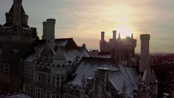 Fresh Snow on the Towers and Chimneys of an Old Castle, Aerial Push In. Drone Parallax Orbit and Dol alt