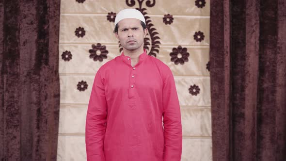 Serious Muslim man looking alt