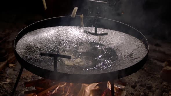 Slow Motion Potatoes Are Poured Into a Frying Pan for Cooking