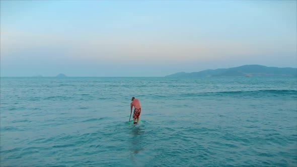 Surfer Flies on the Crest of a Wave a Surfer Controls the Oar Standing on a Surfboard alt