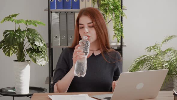 Portrait of businesswoman drinking water at work,Refreshment for businesswoman