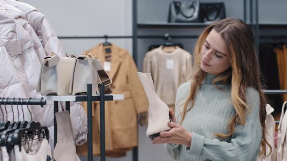 Young Caucasian Stylish Woman Female Consumer Millennial Girl Buyer Client in Boutique Store Chooses alt