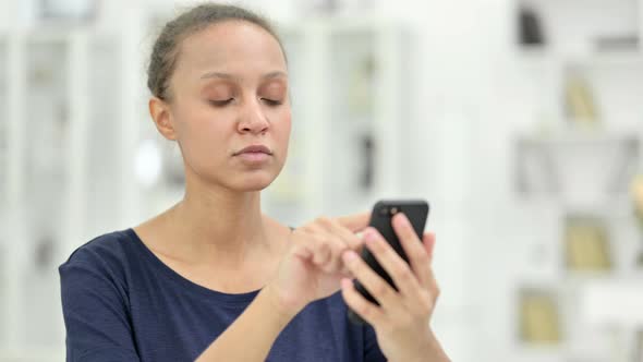 Portrait of Attractive African Woman Using Smartphone  alt