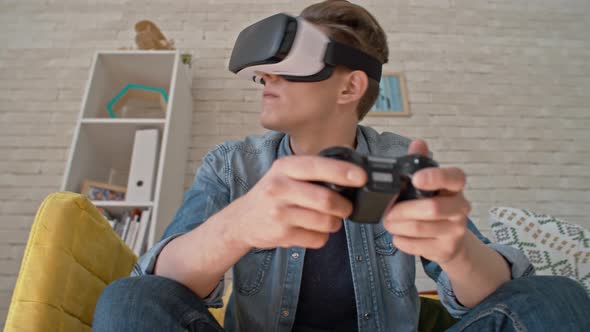 Man in VR Glasses Playing Immersive Video Game alt