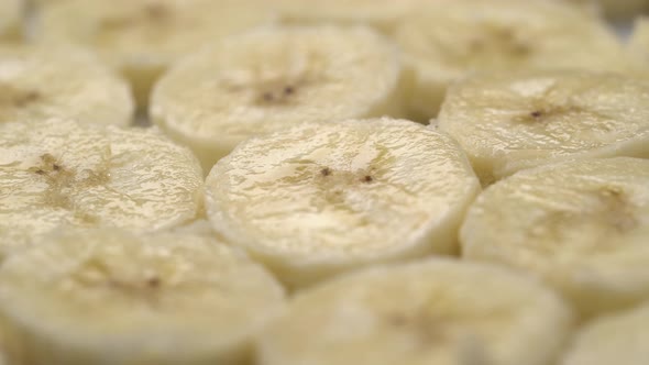 Banana Slices Closeup, Macro Food Summer Background, Fruits Top View. Rotate alt