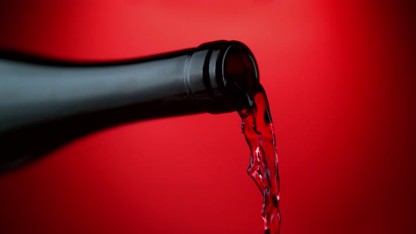 Super Slow Motion Shot of Pouring Red Wine From Bottle with Camera Rotation at 1000Fps alt