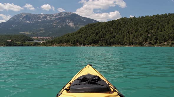 Scenic First Person Landscape View Looking From Yellow Kayak on Mountain Emerald Lake