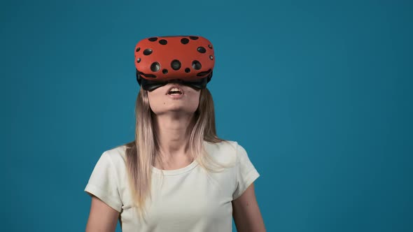 Lady with Orange Virtual Reality Headset Screams at Wall alt
