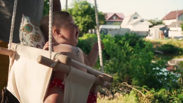 Portrait of a Smiling Caucasian Child Having Fun on a Swing
