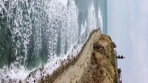 Vertical orientation video: Lighthouse on the sea coast