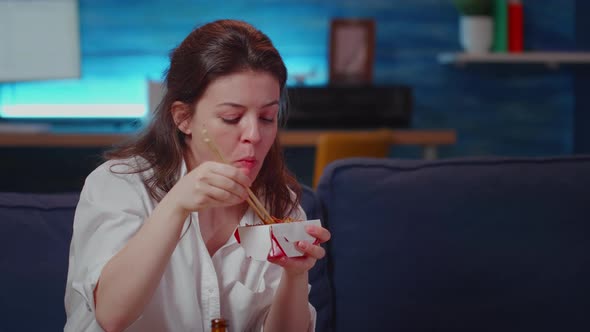 Close Up of Business Woman Eating Asian Food at TV alt