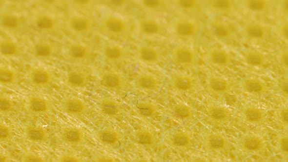 Yellow textile cloth surface texture, macro shot close up view with rotation motion. alt