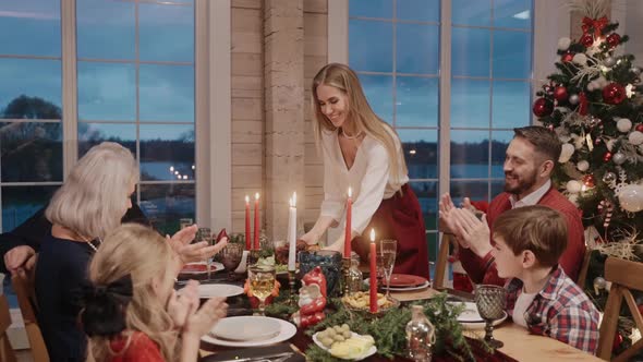 Woman Serves Chicken on the Table on Christmas Eve Everybody Clapping