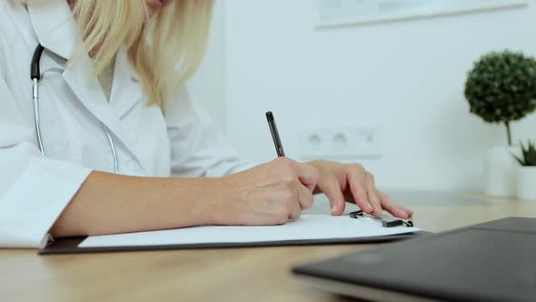 Close Up Female Doctor Writing Notes in Registration Album Managing Patients Appointments at alt