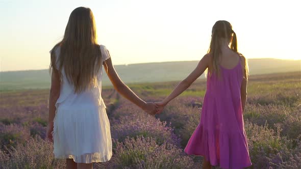 Girls in Lavender Flowers Field at Sunset in White Dress