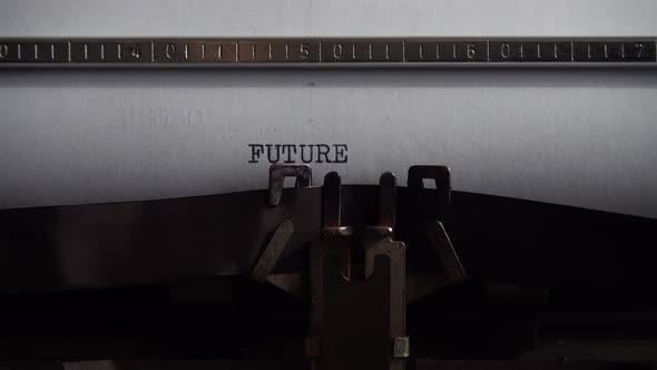 Typing word Future on an old typewriter. Close up. alt