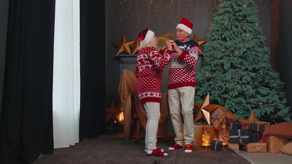 Elderly Family Couple Grandmother Grandmother Dancing at Decorated Home Room with Christmas Tree alt