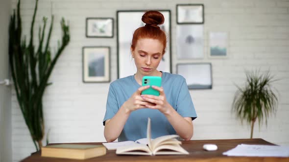 Happy Redhead Young Woman Is Getting Surprisingly Good Online News on Phone. alt