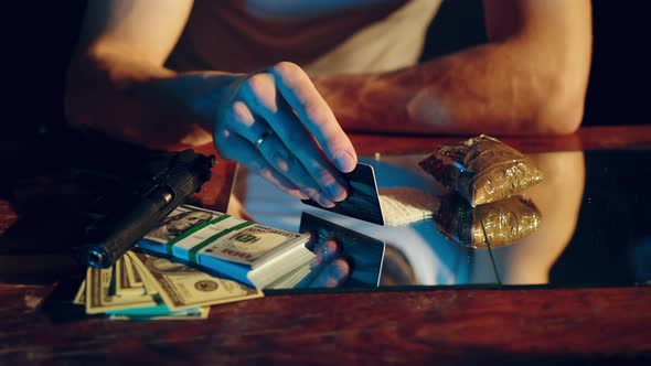 Drugs addict preparing cocaine lines. Cocaine powder sorted. Social problems alt