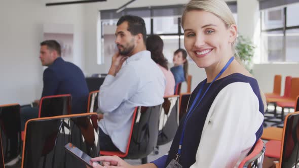 Businesswoman looking at camera in conference room alt