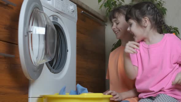 Children wash clothes. alt