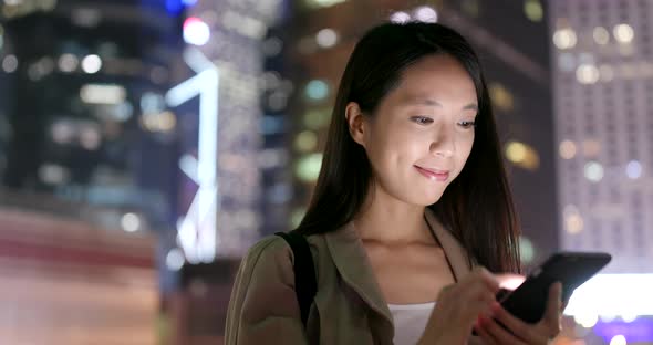 Woman use of smart phone at night alt