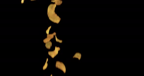 Sweet paprika chips flying in front of black background