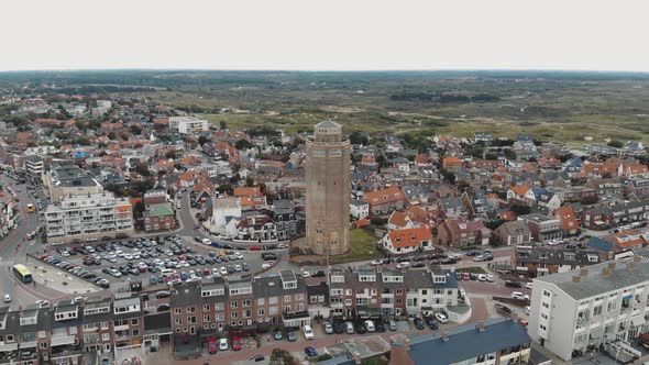 Aerial drone footage of a water tower and the surrounding city of Zandoort, Netherlands. alt