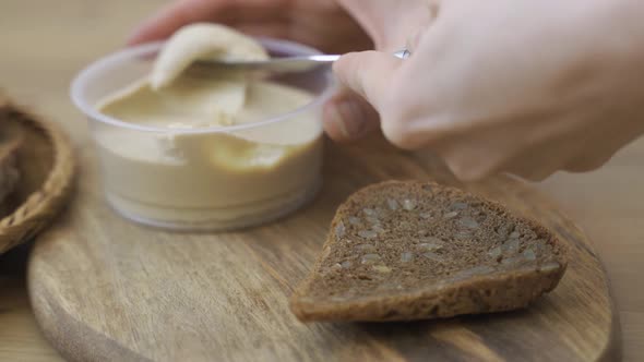 Spreading Vegan Butter On Rye Bread alt