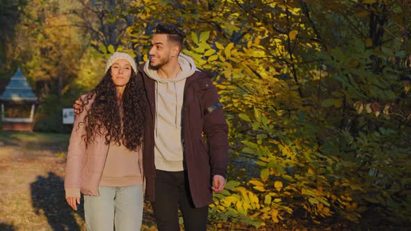 Young Married Couple in Love Walk in Autumn Park in Evening at Sunset Happy Boyfriend and Girlfriend alt