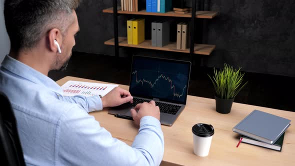 Man Trader Broker Talks to Potential Investor Uses Laptop Stock Exchange Chart alt