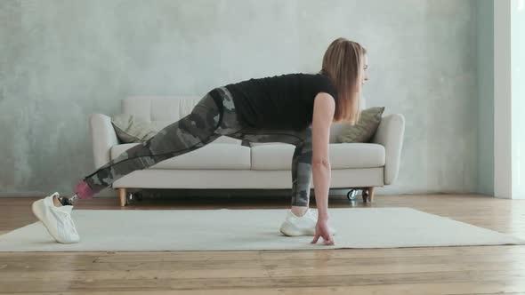 Young attractive woman with prosthetic leg does stretching exercise