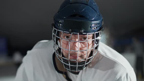 Handheld Portrait of a Forward Hockey Player Seriously Looking at the Camera Steam Coming From the alt
