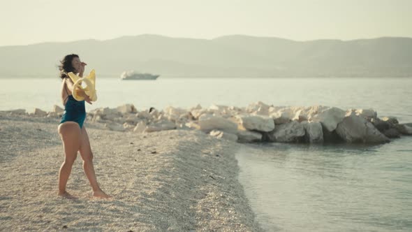 Slow Motion Video of a Girl Undressing on the Beach By the Ocean alt