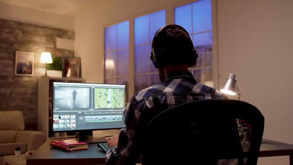 Back View of Young Content Creator Working on a Movie Project alt