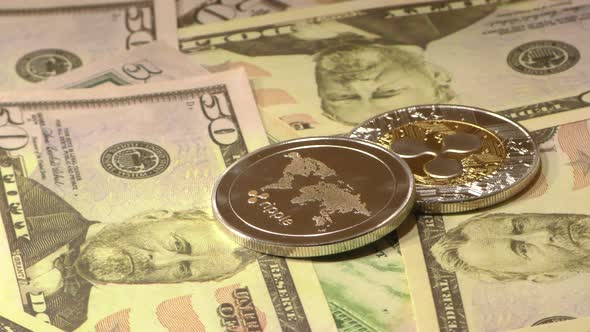 Ripple Coins Rotating on Bills of 50 Dollars. Worldwide Virtual Internet Cryptocurrency. alt