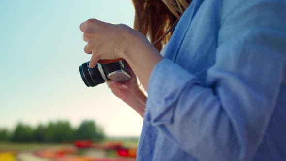 Closeup Woman Hands Holding Professional Photo Camera in Blooming Garden Outdoor alt
