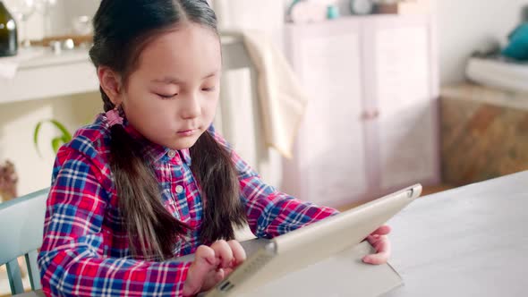 Asian Girl Surfing the Internet on Digital Tablet