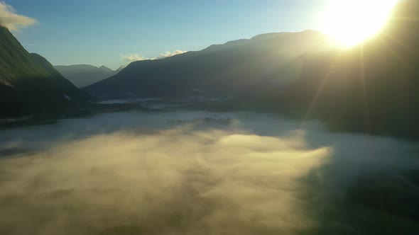 Morning Mist Over the Valley Among the Mountains in the Sunlight alt