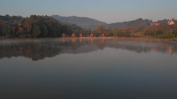 Misty Sunrise Over Lake at Alpine Countryside alt