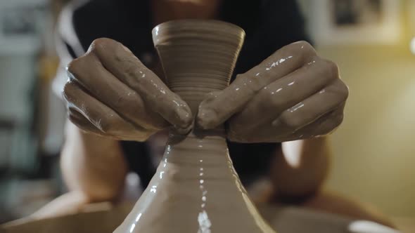 Female Hands Form Neck of an Earthenware Jug From White Clay on Potter's Wheel