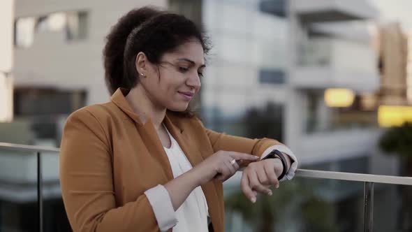 Young Businesswoman on Work Break Texting on Smartwatch in City