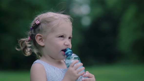 Drink Water. Little Girl Drinking Water From Bottle Outdoors alt