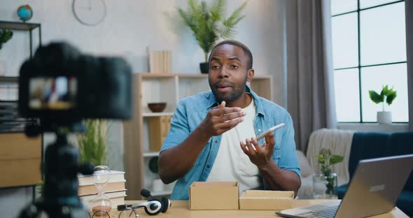 Blogger Telling About New Smartphone Opportunities On Camera for Internet Spectators on Home alt