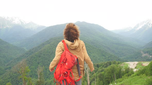 Traveler Man with Backpack Raised Hands. Mountains Landscape on Background alt