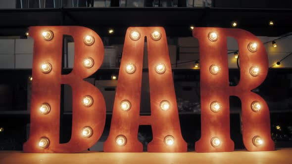 Light Bulb Glowing Letter on Factory Warehouse alt